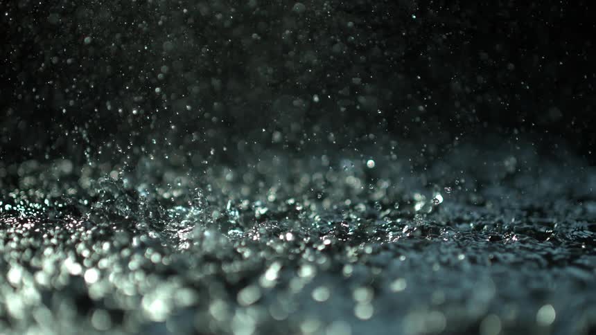 Water drops falling on the surface of a body of water