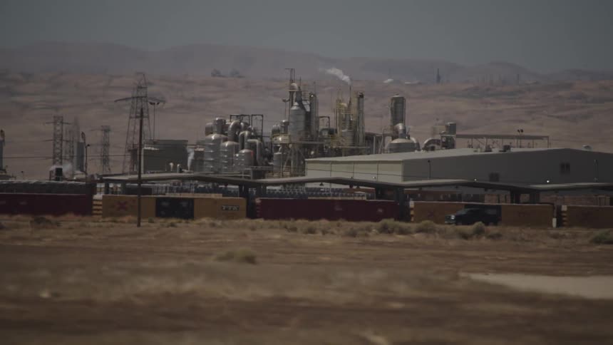 Cars are driving near a power plant