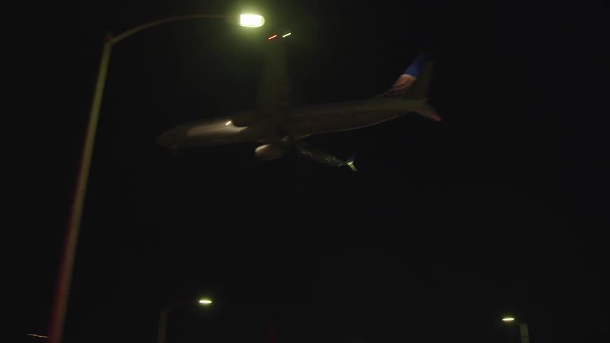 An airplane is flying above a city