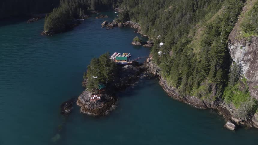 Buildings occupy small peninsula near place ocean and mountain meet