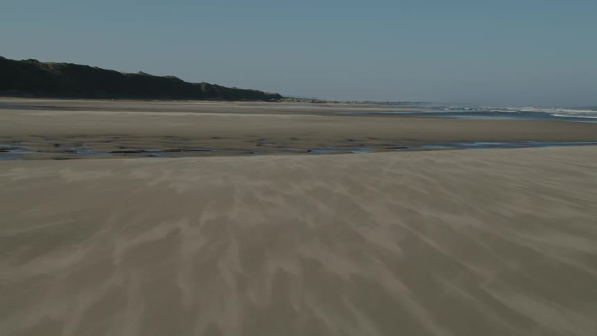 Landscape view of a beach with hills in the distance