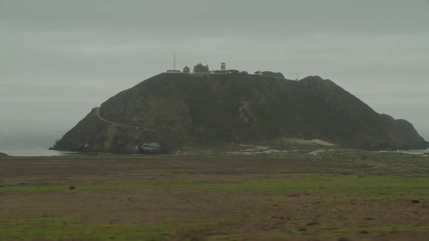 Buildings on top of a hill on the coast