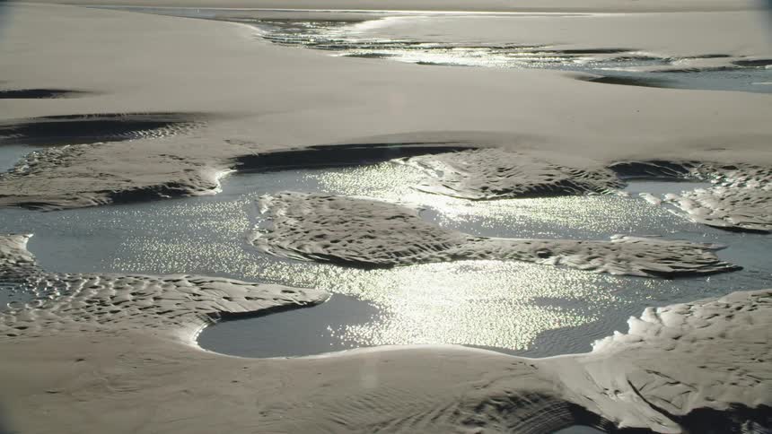 Water travels through a sand bar