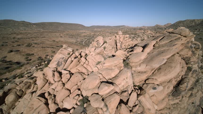 An aerial view of a cliff is displayed