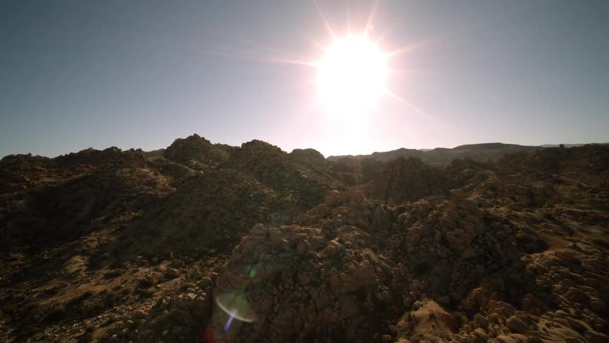The sun over rocky ground
