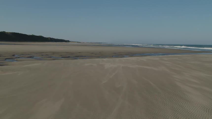Empty stretch of large sandy beach