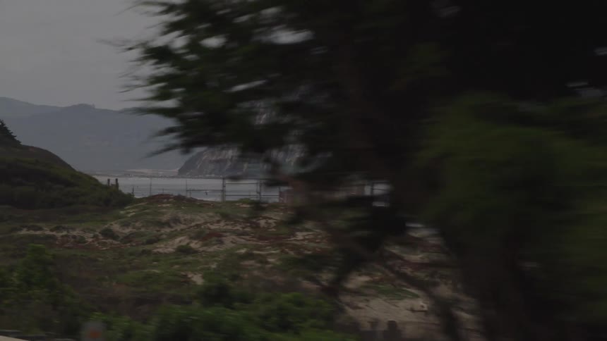 People walk along the beach on a foggy day