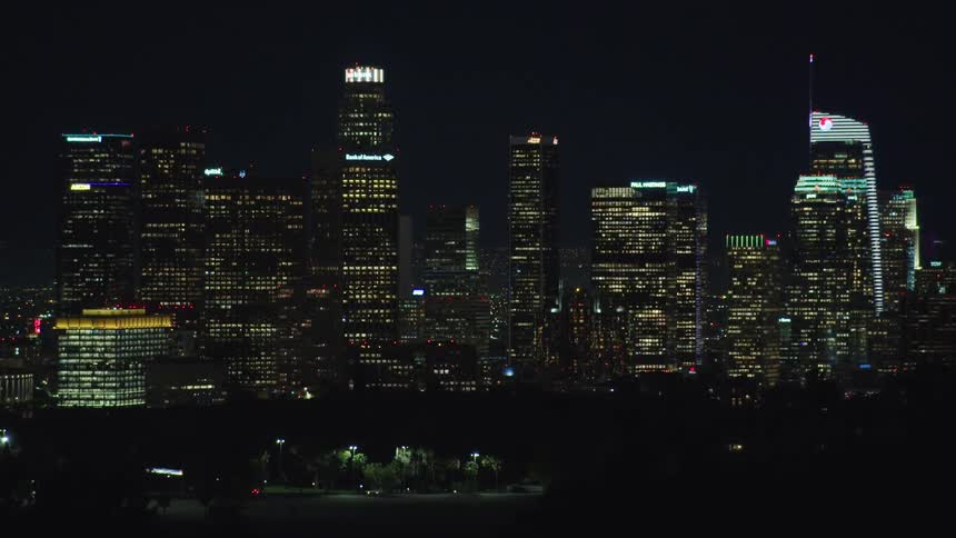 An aerial view of a downtown city skyline is displayed