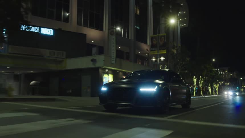 Car driving on city streets at night