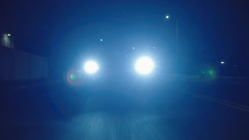 A car drives very fast down a street