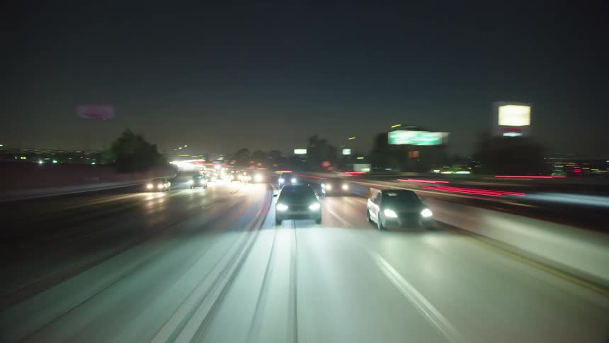 High speed footage of cars traveling on freeway at night