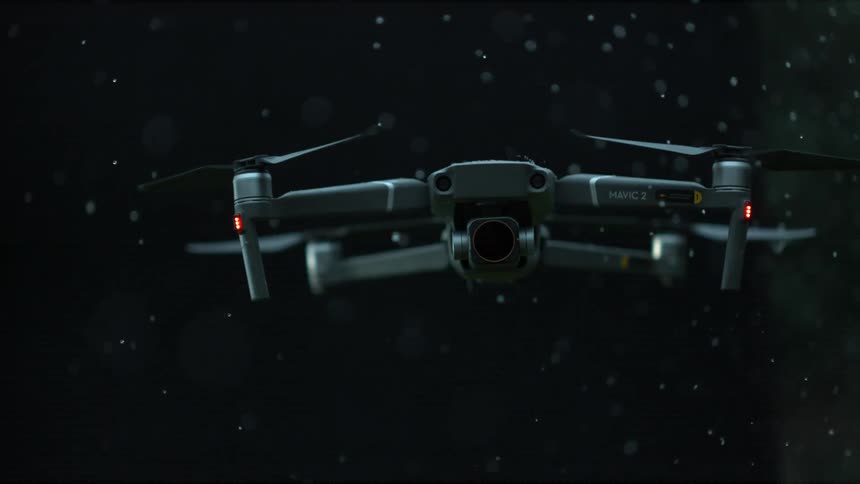 Drone hovering in the air in slow motion in the rain