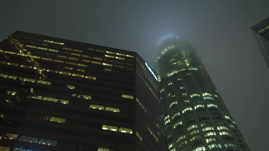 Skyscraper covered in fog at night in the city