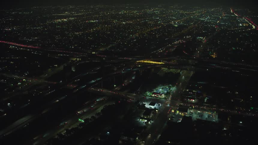 Cars drive in the city at night