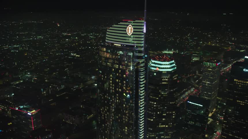 Aerial view of the illuminated skyscraper and tall buildings at night