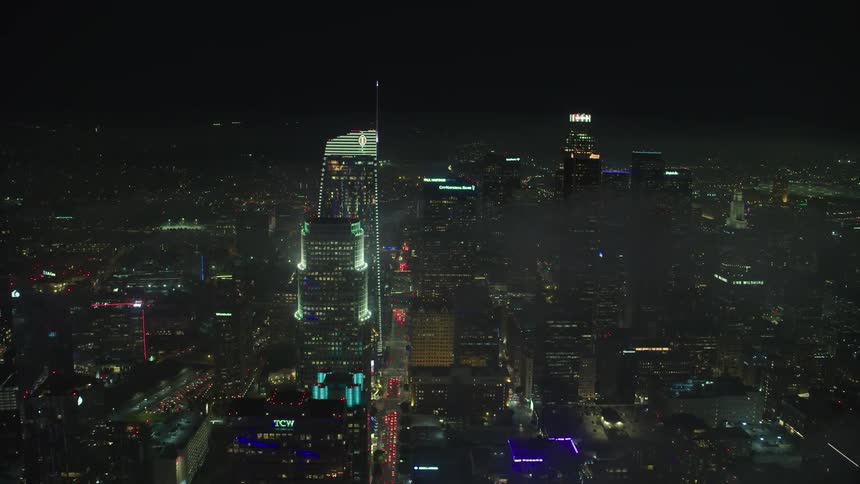 City lights shine in through fog in the night