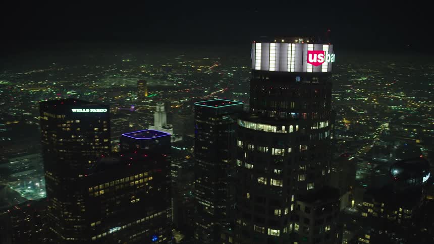 Downtown at night is lit up by skyscrapers