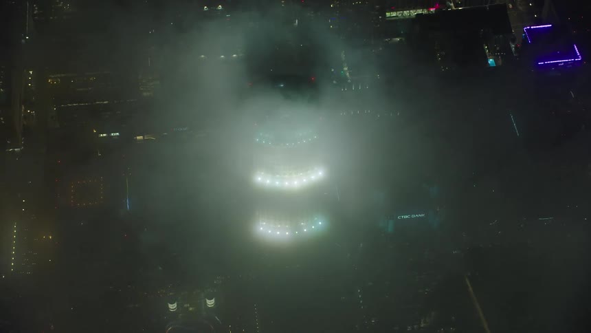 Aerial view of the skyscraper covered in fog at night