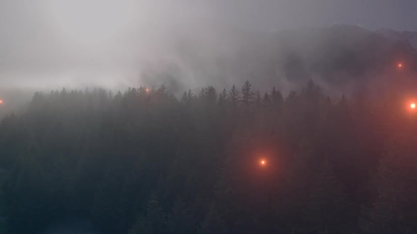 Smoke fills the sky above the treeline