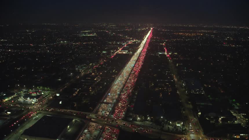 Traffic travels on the freeway and overpass at night