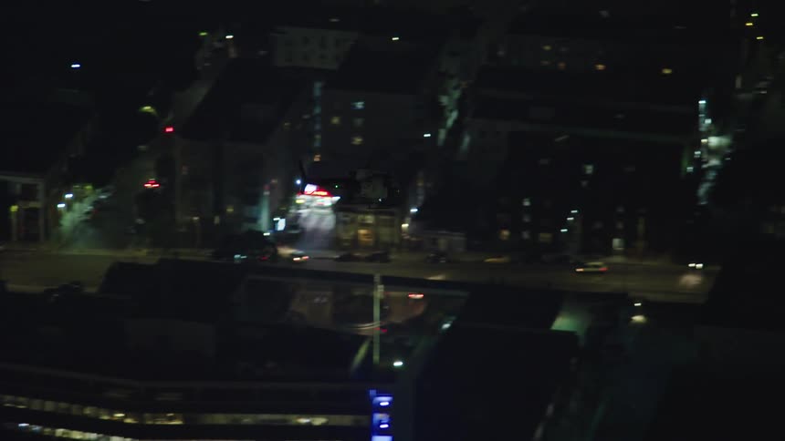 The helicopter flies over the baseball stadium