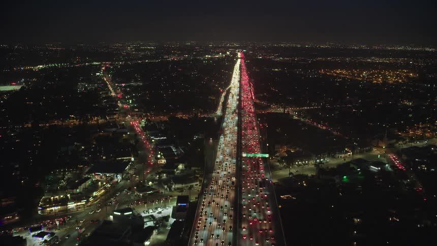 Aerial of commuters traveling in traffic on highway at night
