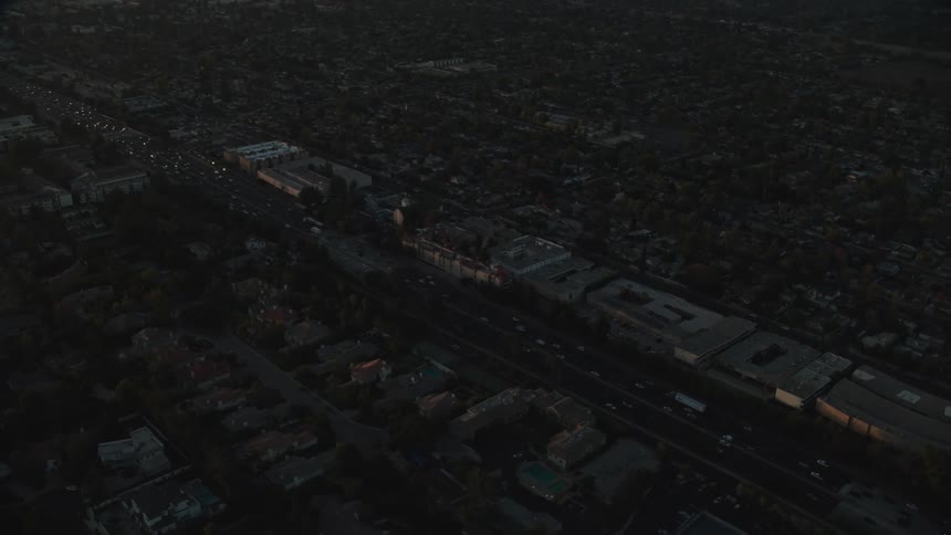 Cars drive on a highway in a large city