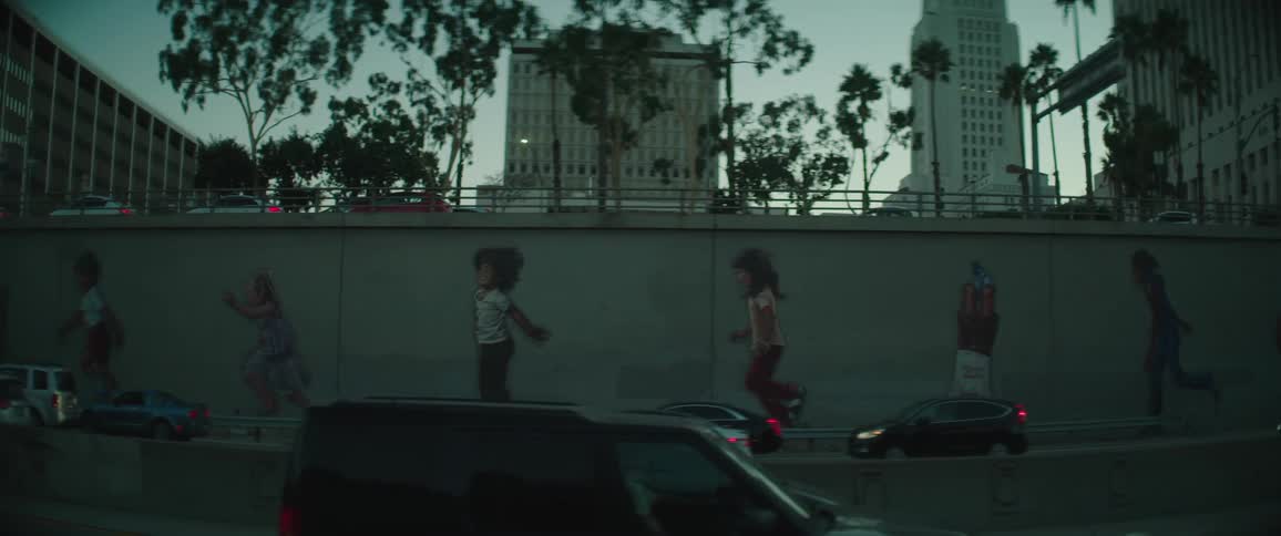 Vehicles drive along highway in the city
