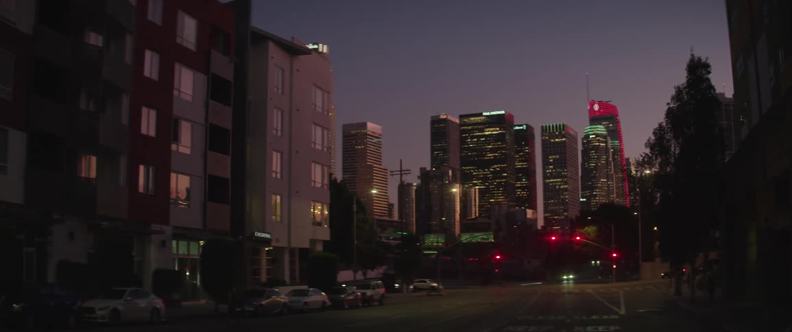 Cars are driving in a downtown city