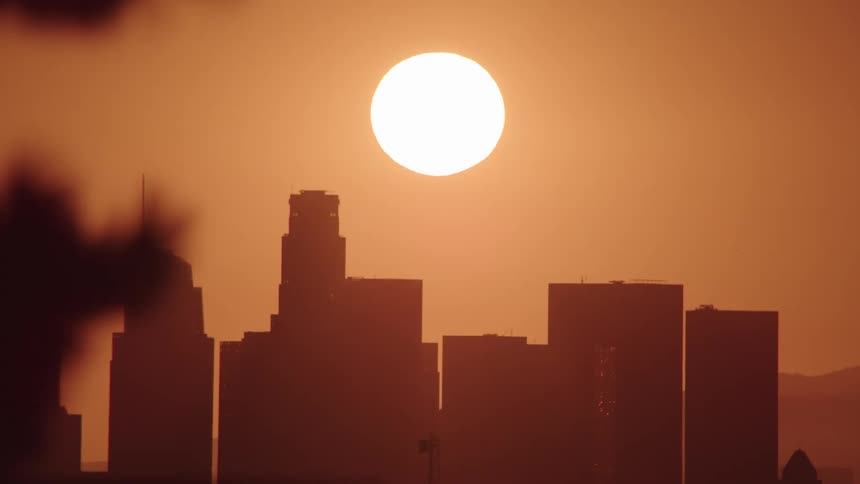 The sun above the city skyline