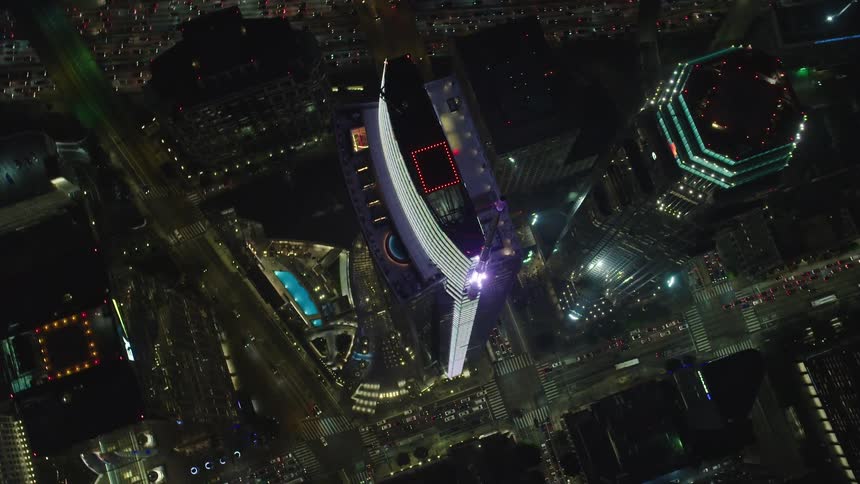 Skyscraper lights and traffic glow at night in the city