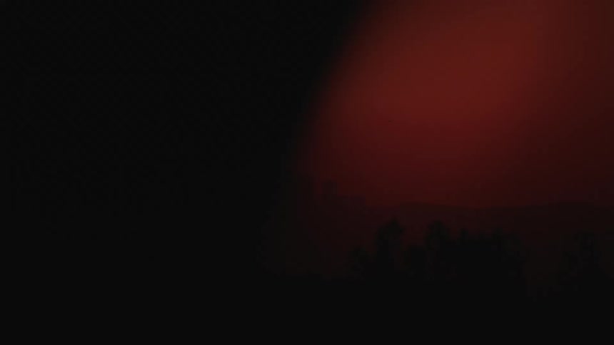 The sun is setting and the sky is red