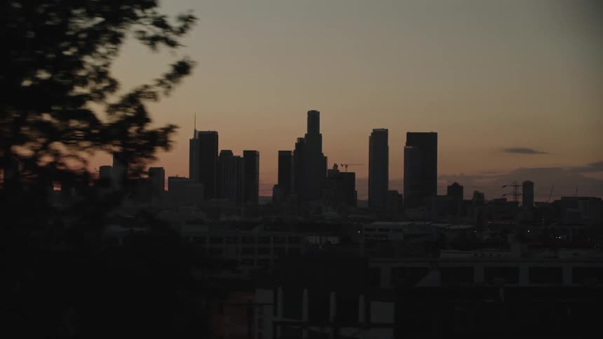 Afterglow tints the sky behind the city skyline just after dusk