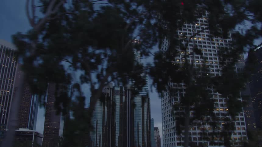 The sun is setting behind the buildings of the city