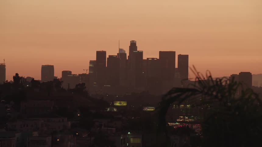 Los angeles city skyline silhouetted against sunset
