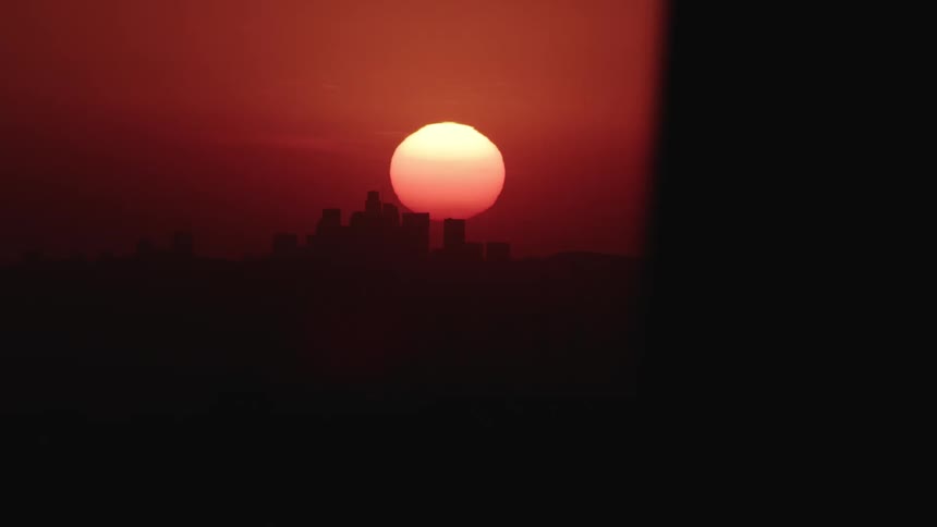 The sun is setting along the skyline