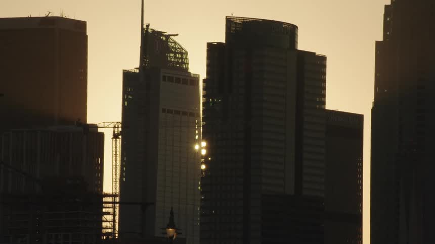 Sun shines through the skyscrapers in the city