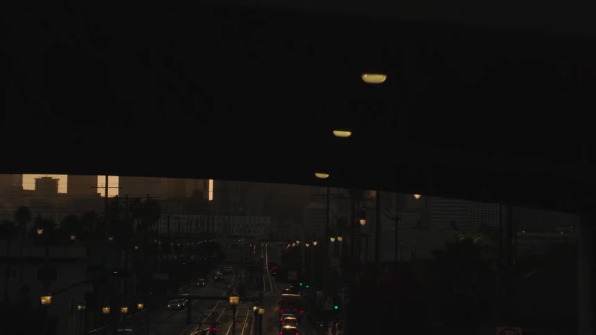 A city road with an overpass and buildings in the foreground