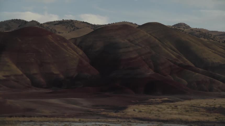 Desert rock formations with striations under a blue sky