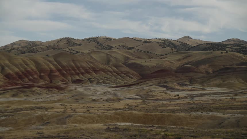 The hills in the desert lead to a mountain range