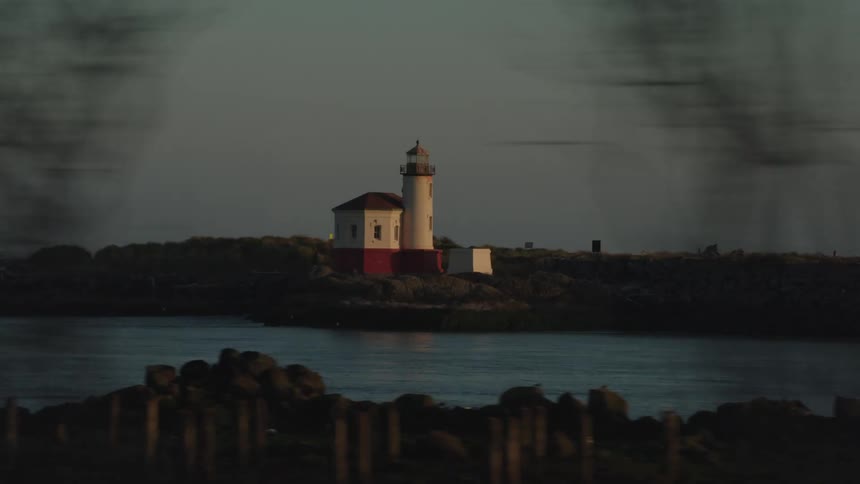 A lighthouse sits next to a body of water