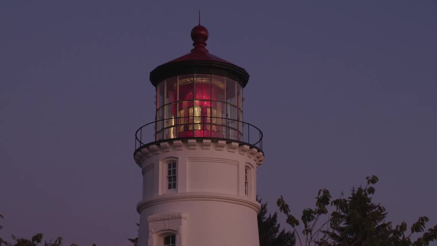 A lighthouse is displayed surrounded by trees