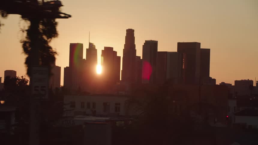 The sun shines through the skyscrapers in the city