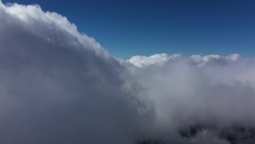 The sky above the clouds is blue