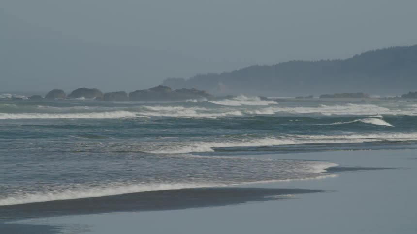 The tide washing into a beach during the day