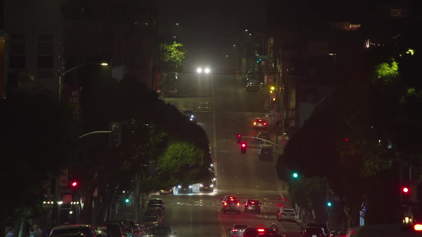 Cars driving on city streets at night