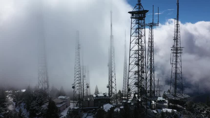 Towers jutting up into low clouds during the day