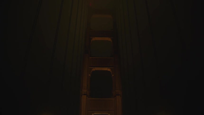 Cars driving on suspension bridge at night