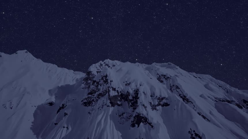 A star filled sky over a snowy mountain range