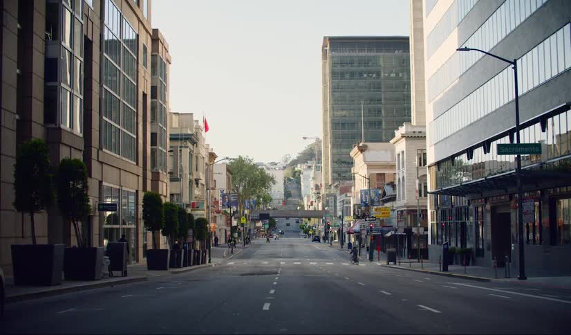Empty downtown with a lone pedestrian crossing crosswalk in the distance